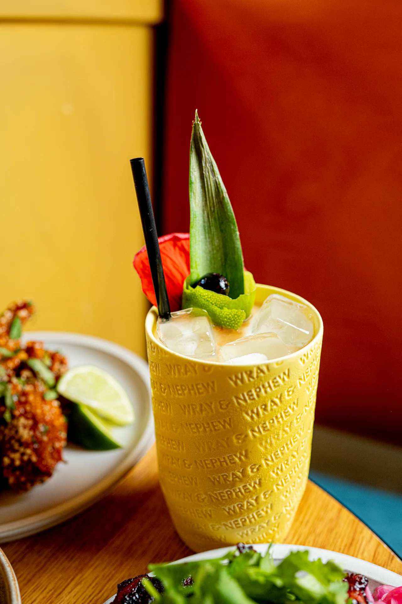 Golden cocktail with a pineapple leaf garnish